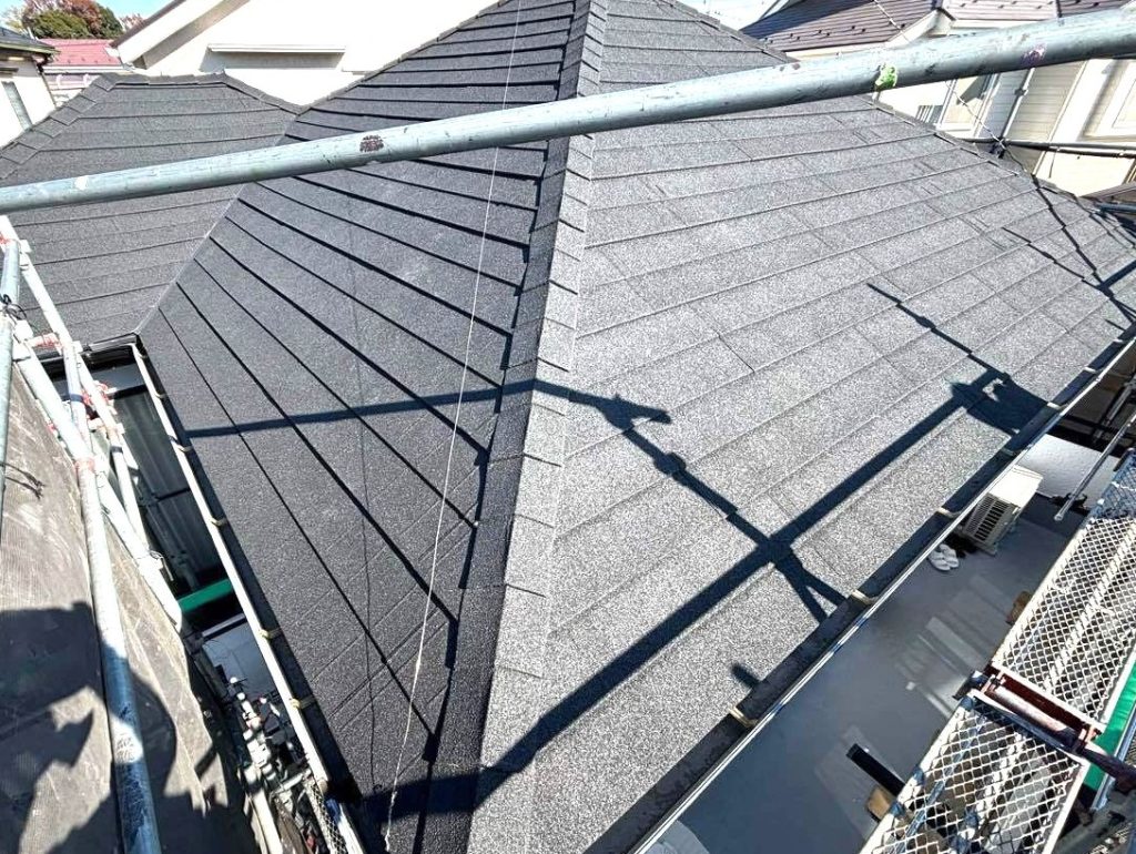 ディプロマットでカバー工事を行った後の屋根の写真です。カラーはオニキスというブラック系です。ディプロマットで施工した場合、棟板金やケラバも同質で施工をするため「捨て板金」部分が目立つようになります。　　「板金が見えている。施工不良ではないか？」とお問い合わせをいただくことがあるのですが、この捨て板金はケラバの部分や谷の加工のところで、屋根の下に水を受けても流せるように設置しています。水が流れる道を作ってあげないと逃げ場がなくなり、のちに漏水へとつながってしまう場合があります。