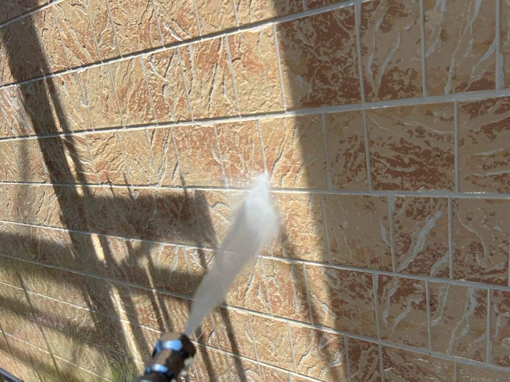 塗装前に高圧洗浄を行います。高圧洗浄は、外壁の塗装を長持ちさせるために非常に重要な工程です。高圧洗浄機を使用して、外壁や屋根の汚れや古い塗膜をしっかりと落とすことで、新しい塗料が密着し、剥がれやひび割れを発生させにくくさせます。