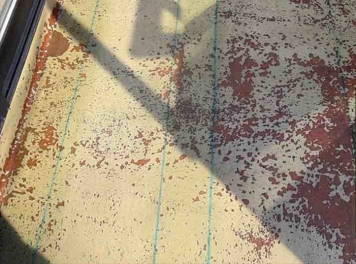 ベランダ防水の核となる「積層（せきそう）」の工程です。強靭なガラス繊維でできたマットを敷き詰め、その上から防水樹脂を流し込んで一体化させていきます。専用の脱泡ローラーを使い、樹脂の中に入り込んだ空気を一箇所ずつ丁寧に押し出していくことで、水を通さない強固な防水膜が完成します。厚みを均一に保ちながら継ぎ目のないシームレスな層を作ることで、今回、2プライ（2層）の厚膜を形成し、ベランダの防水性を高めます。